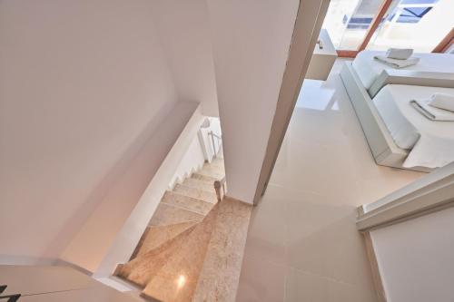 a staircase in a house with white walls and windows at Villa Elmas in Kalkan