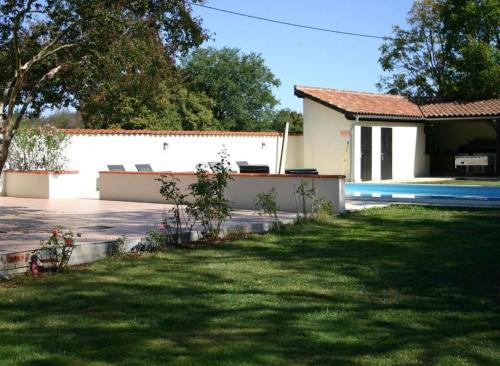 a house with a swimming pool and a yard at Domaine Manon in Buzon