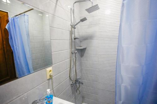a bathroom with a shower and a sink and a mirror at city point in Kutaisi