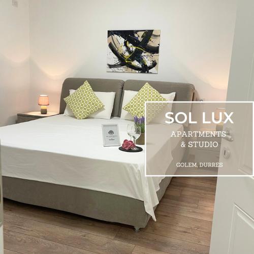 a bedroom with a bed with white sheets and pillows at SOL Lux Apartments 1st Floor in Durrës