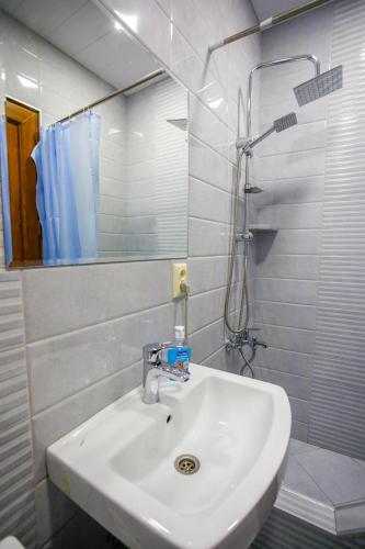 a bathroom with a white sink and a shower at city point in Kutaisi