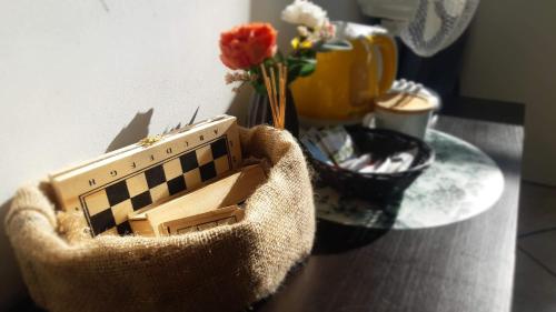 a basket sitting on top of a table with flowers at Mhost Bronowice in Kraków