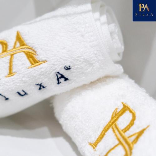 a pair of towels with the wordania written on them at Pluxa Sunstone Deluxe - Spacious Birmingham City Centre Stay in Birmingham