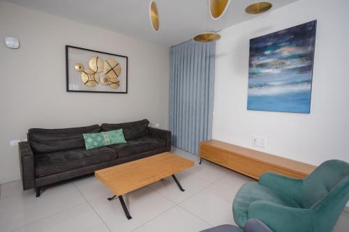 a living room with a couch and a table at Luxury apartments Boutique Haneviim in Jerusalem