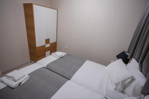 a small bedroom with two beds and a mirror at Luxury apartments Boutique Haneviim in Jerusalem