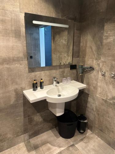 a bathroom with a white sink and a mirror at Bed&Breakfast de Hooimoat in Losser