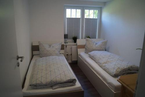 Postel nebo postele na pokoji v ubytování Ferienwohnung Ankerplatz in Schlagsdorf auf Fehmarn