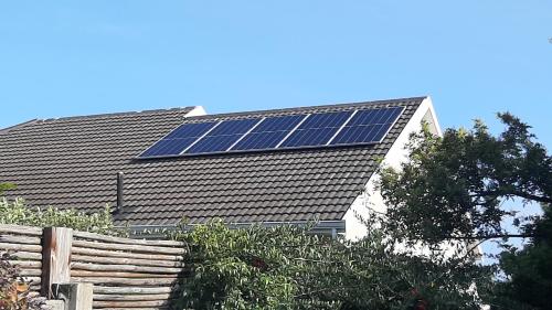 a roof with solar panels on top of a building at Garden- Pool flat with Solar Electricity in Somerset West