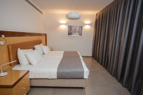 a hotel room with a bed and a window at Luxury apartments Boutique Haneviim in Jerusalem
