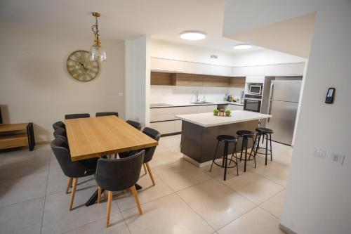 a kitchen and dining room with a table and chairs at Luxury apartments Boutique Haneviim in Jerusalem