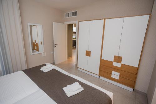 a bedroom with a bed with two towels on it at Luxury apartments Boutique Haneviim in Jerusalem