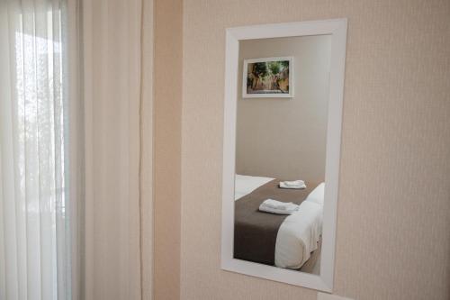 a mirror in the corner of a room with a bed at Luxury apartments Boutique Haneviim in Jerusalem