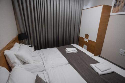 a hotel room with a bed with two towels on it at Luxury apartments Boutique Haneviim in Jerusalem