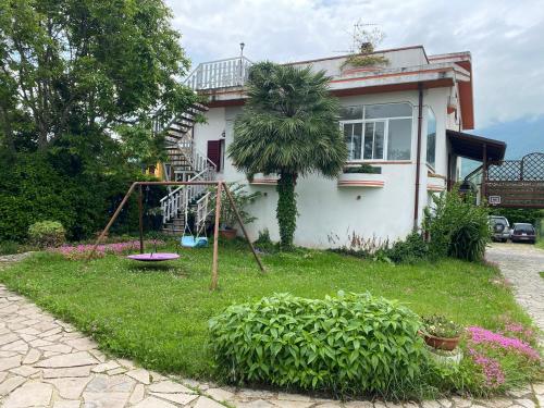 a house with a playground in front of it at Villa Ulivi in Tocco da Casauria
