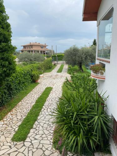 a stone walkway in front of a house with plants at Villa Ulivi in Tocco da Casauria