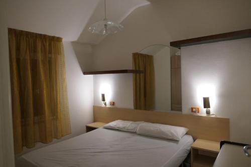 a bedroom with a bed and a large mirror at Quadrifoglio 43 in Bibione