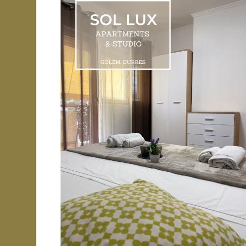 a catalogue of a spa room with a bed and a mirror at SOL Lux Apartments 2nd Floor in Durrës