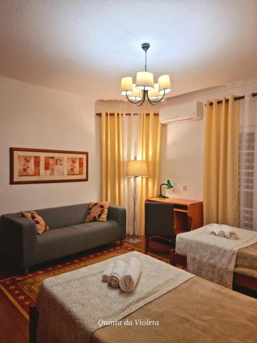 a living room with a couch and a table at Villa Quinta da Violeta in Loulé