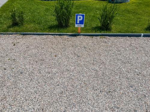 a blue parking sign sitting on the side of a road at Deluxe Room 33 in Bled