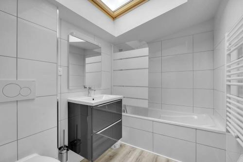 a white bathroom with a sink and a shower at LA MEDITERRANEENNE in Quint-Fonsegrives