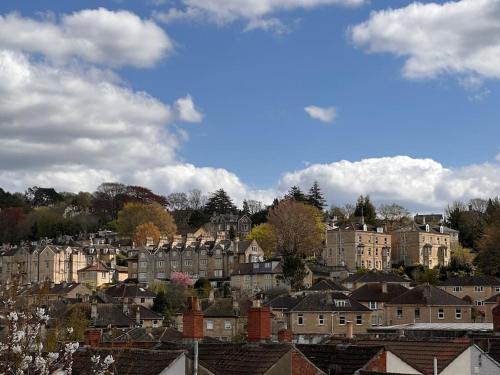 a city with houses and buildings on a hill at Cosy 19th century two bedroomed home with continental Breakfast in Bath