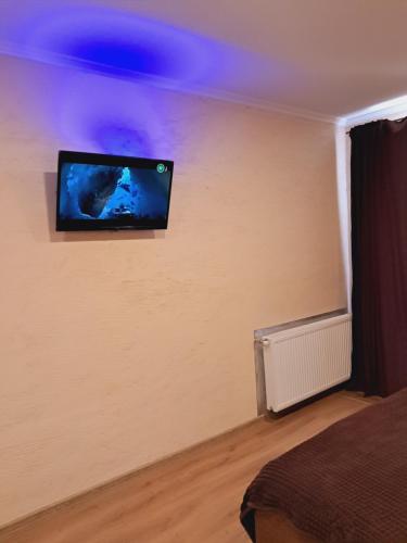 a room with a flat screen tv on a wall at New modern apartments in the center in Ivano-Frankivsk