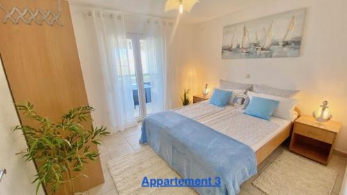 a bedroom with a large bed with blue pillows at Croadriatic Apartments in Vir