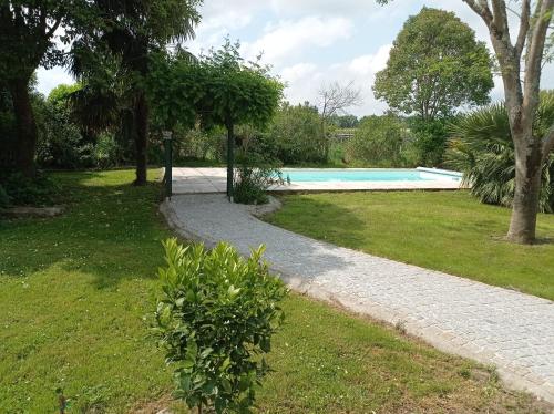 a stone walkway leading to a swimming pool at Michel et Florence in Peyrehorade