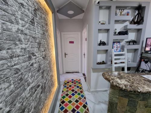 a hallway with a stone wall and a stairway at Spring house in Qaryat Shākūsh