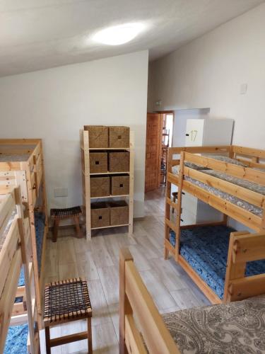 a room with bunk beds and a room with boxes at ZENIA HOSTEL in Playa Flamenca