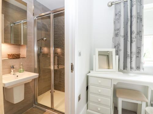 a bathroom with a shower and a sink at East View in Cheltenham