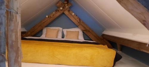 a bedroom with a bed in the attic at vakantieboerderij Aardenhof in Sevenum