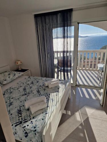 a bedroom with a bed with a view of the ocean at Apartmani Krepelnik in Drage