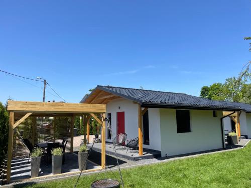 a small house with a pitched roof at RedDoor Zator Lake Houses in Zator