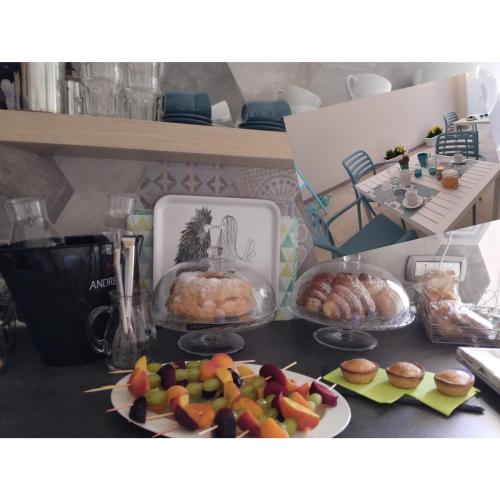 a table with a plate of fruit and pastries at B&B Sole Mare Vento in Maruggio