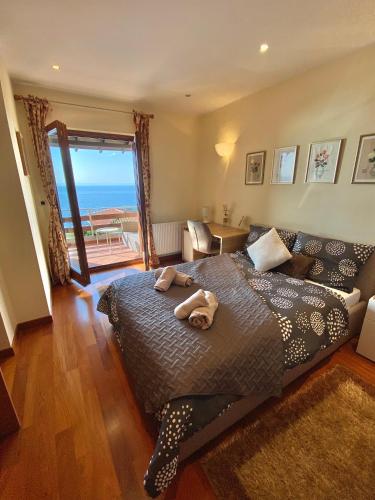 a bedroom with a bed with a view of the ocean at VILLA LOVRAN - 150 m to the beach - infinity pool - incredible sea view - fitness gym in Lovran