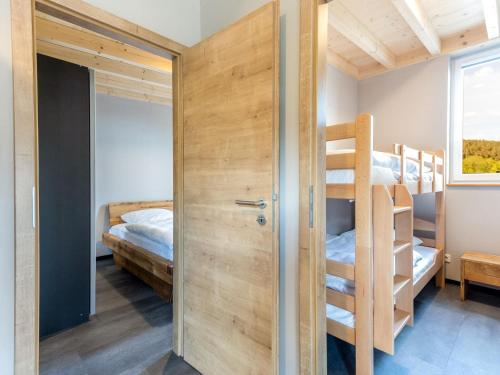 a room with two bunk beds and a closet at Hallschlag Nature Bungalow in Hallschlag