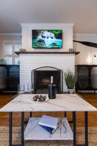 a living room with a fireplace with a tv above it at Ocean View Terrace in Hampton Bays