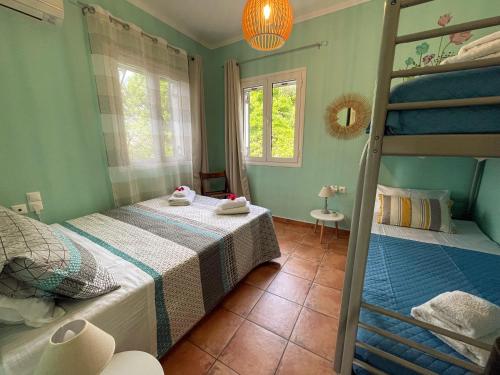 a bedroom with two beds and a bunk bed at Villa Pigi in Méson Yerakaríon