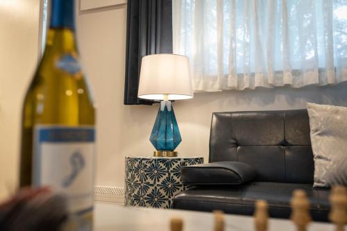a lamp sitting on a table next to a couch at Ocean View Terrace in Hampton Bays