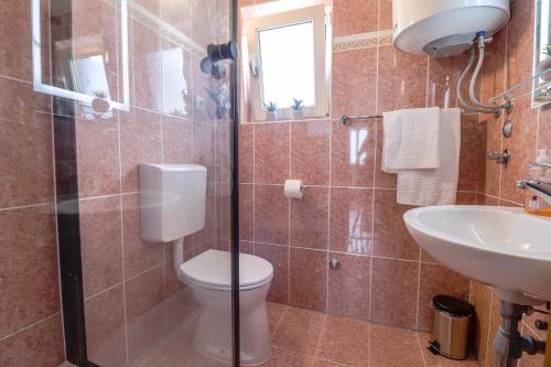 a bathroom with a toilet and a sink at 4 You Apartments in Mugeba