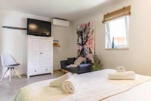 a bedroom with a bed and a tv on a wall at 4 You Apartments in Mugeba