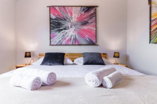a bedroom with a white bed with towels on it at 4 You Apartments in Mugeba