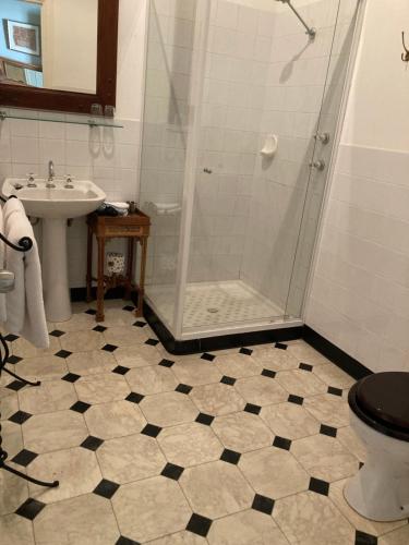a bathroom with a shower and a toilet and a sink at Faversham House in York