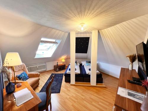 a living room with a bed and a couch and a table at Ferienwohnung Luna -3 Schlafzimmer, Waschmaschine, Küche, WLAN, ca 15 Min bis zum Europa Park, in Malterdingen