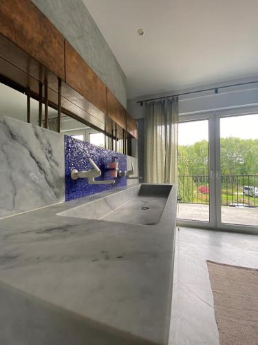 a kitchen with a concrete counter and a sink at Hof Arche in Neuenkirchen-Vörden