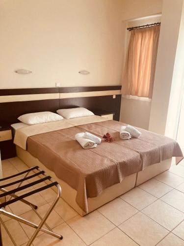 a bedroom with a bed with two towels on it at VILLA HARIKLIA in Paralia Katerinis