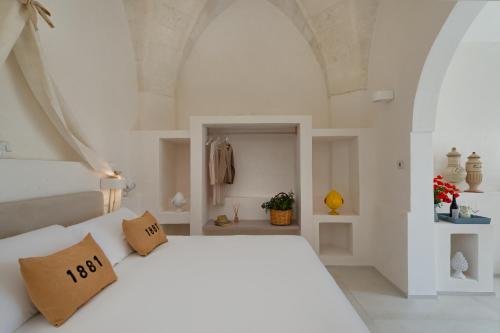 Katil atau katil-katil dalam bilik di Masseria Cuturi