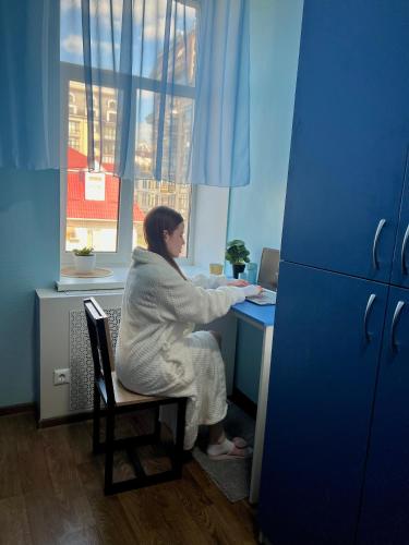 a woman sitting at a desk in an office at Hostel on Universytet in Kyiv