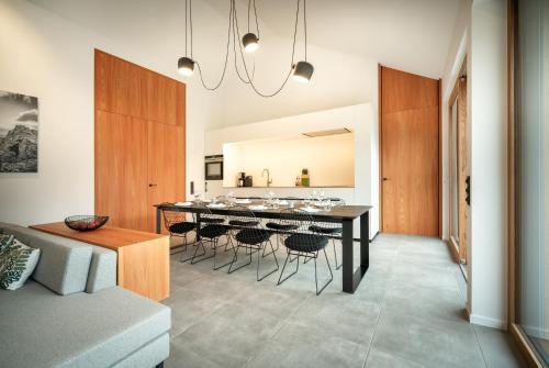 a dining room and kitchen with a table and chairs at B-Lodge Kärnten in Kirchbach